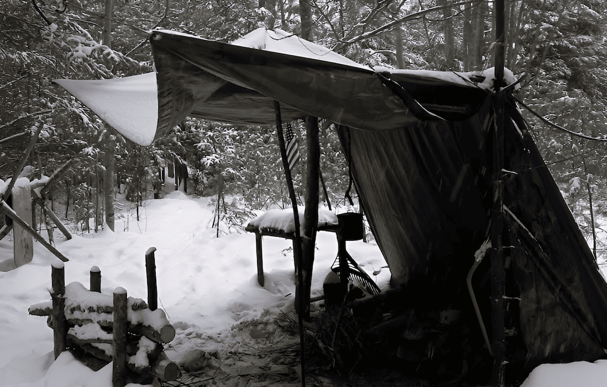 using a tarp to build a simple camping lean to shelter in the forest