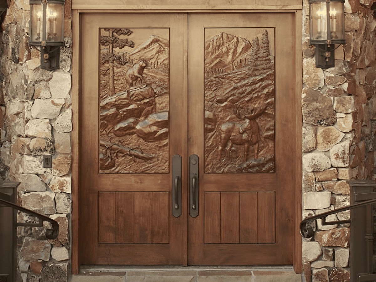 hand carved front entry wood door with animal inlays
