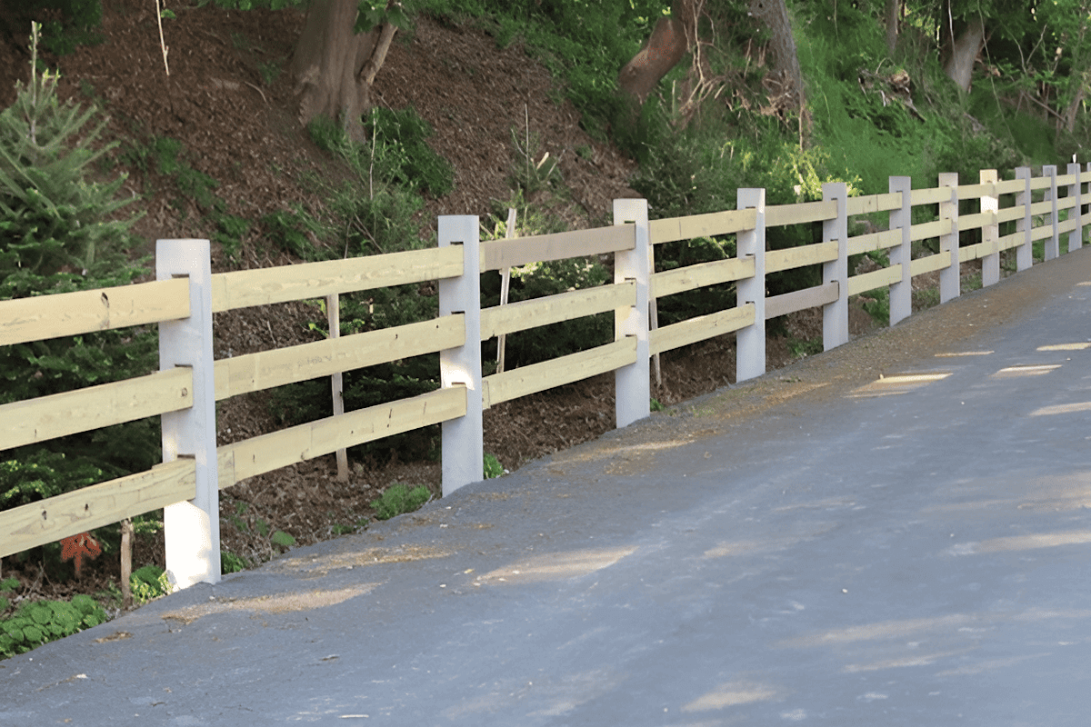 Concrete fence posts supporting rails and slats for a garden boundary fence