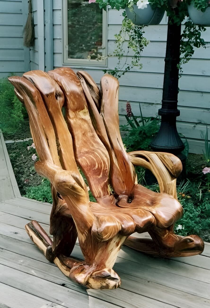 Handcrafted driftwood rocking chair with natural wood curves on outdoor porch