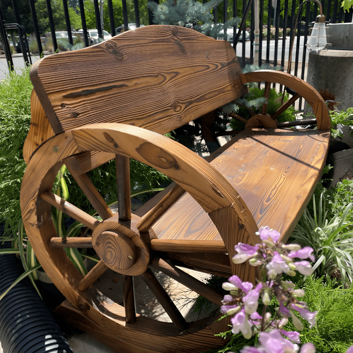 using a wood wagon wheel as a trellis in the garden