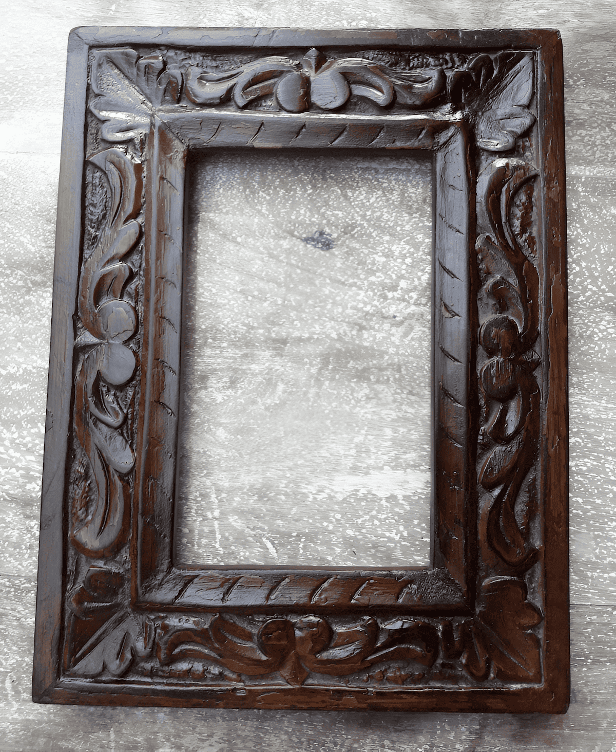 hand carved walnut picture frame showing intricate traditional craftsmanship