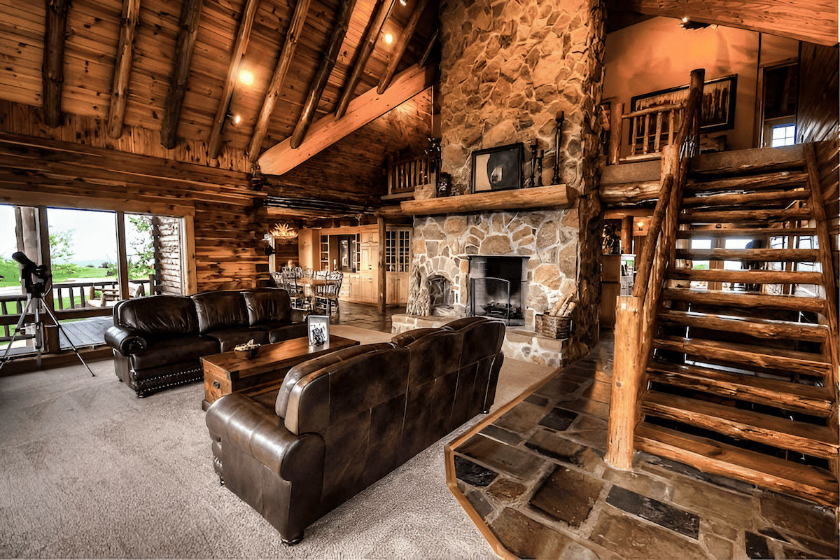 beautiful log home interior with wood beams and stone fireplace