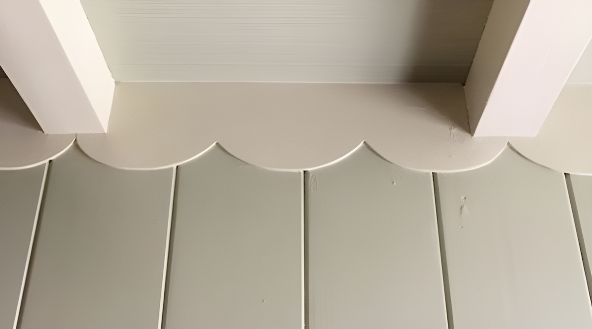 old fashioned style scalloped wood trim along a wall edge