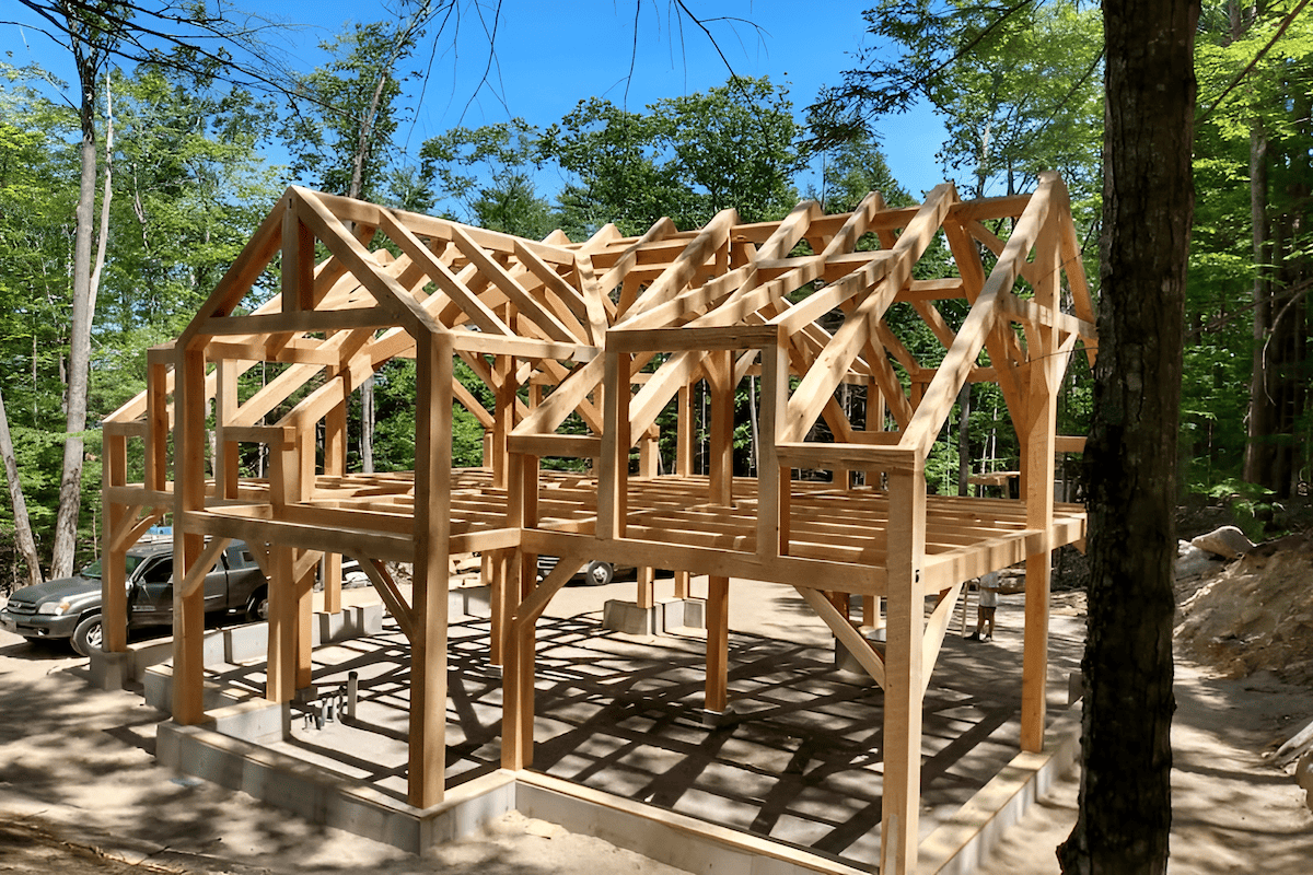 timber frame house structure with exposed wood beams ready for exterior cladding