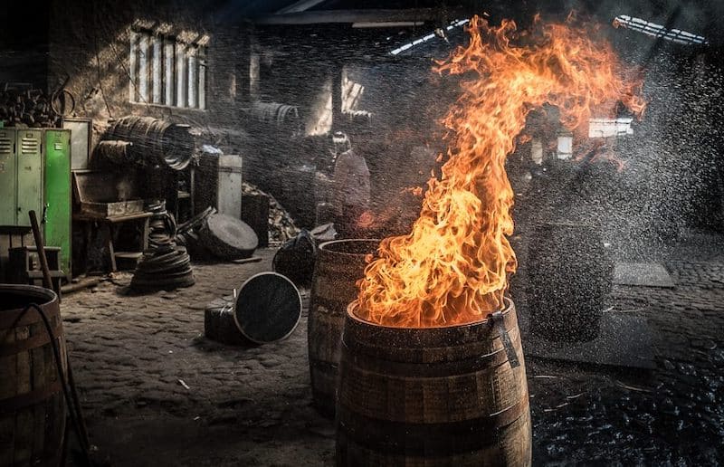 toasting and seasoning an oak whiskey barrel with fire