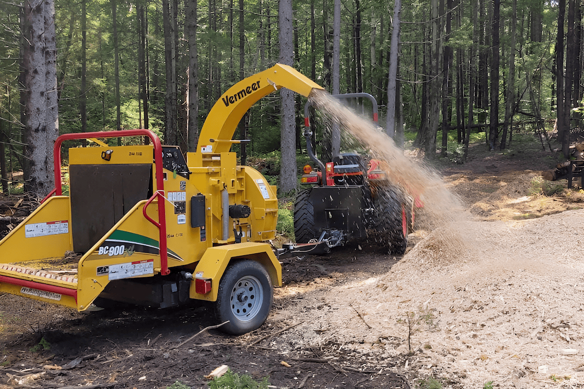 gas-powered wood chipper creating wood chips from branches